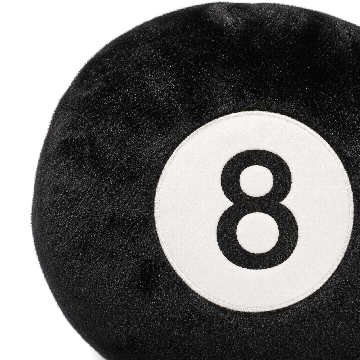Close-up of black plush fabric and the white 8-ball face