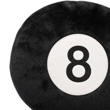 Close-up of black plush fabric and the white 8-ball face