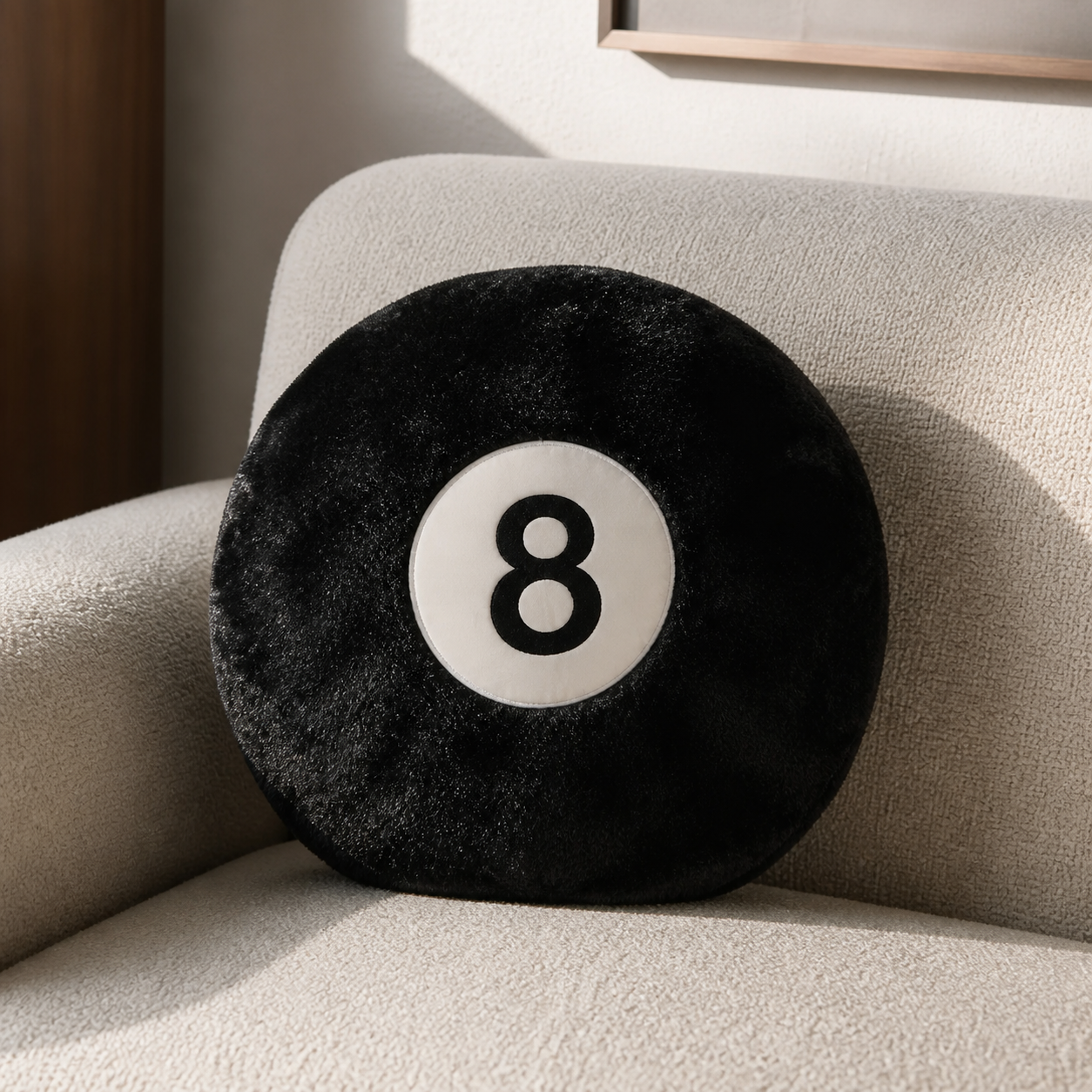 Black 8-Ball Pillow styled on a cream couch in a modern interior