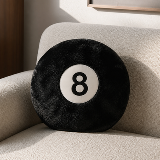 Black 8-Ball Pillow styled on a cream couch in a modern interior
