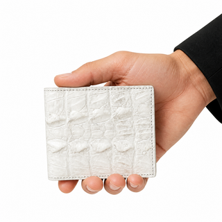 Close-up hand holding the Aegis Himalayan Crocodile Wallet on white