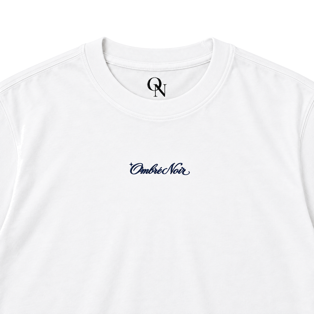After Hours white graphic tee detail: ribbed collar, inner-neck mark and navy chest script