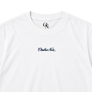 After Hours white graphic tee detail: ribbed collar, inner-neck mark and navy chest script