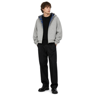 Model wearing the Counterform Cobalt Reversible Hoodie on a white studio background