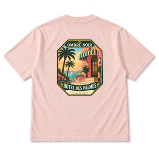 Hôtel des Palmes Graphic Tee in Salmon, back view with palm-lined seaside hotel illustration