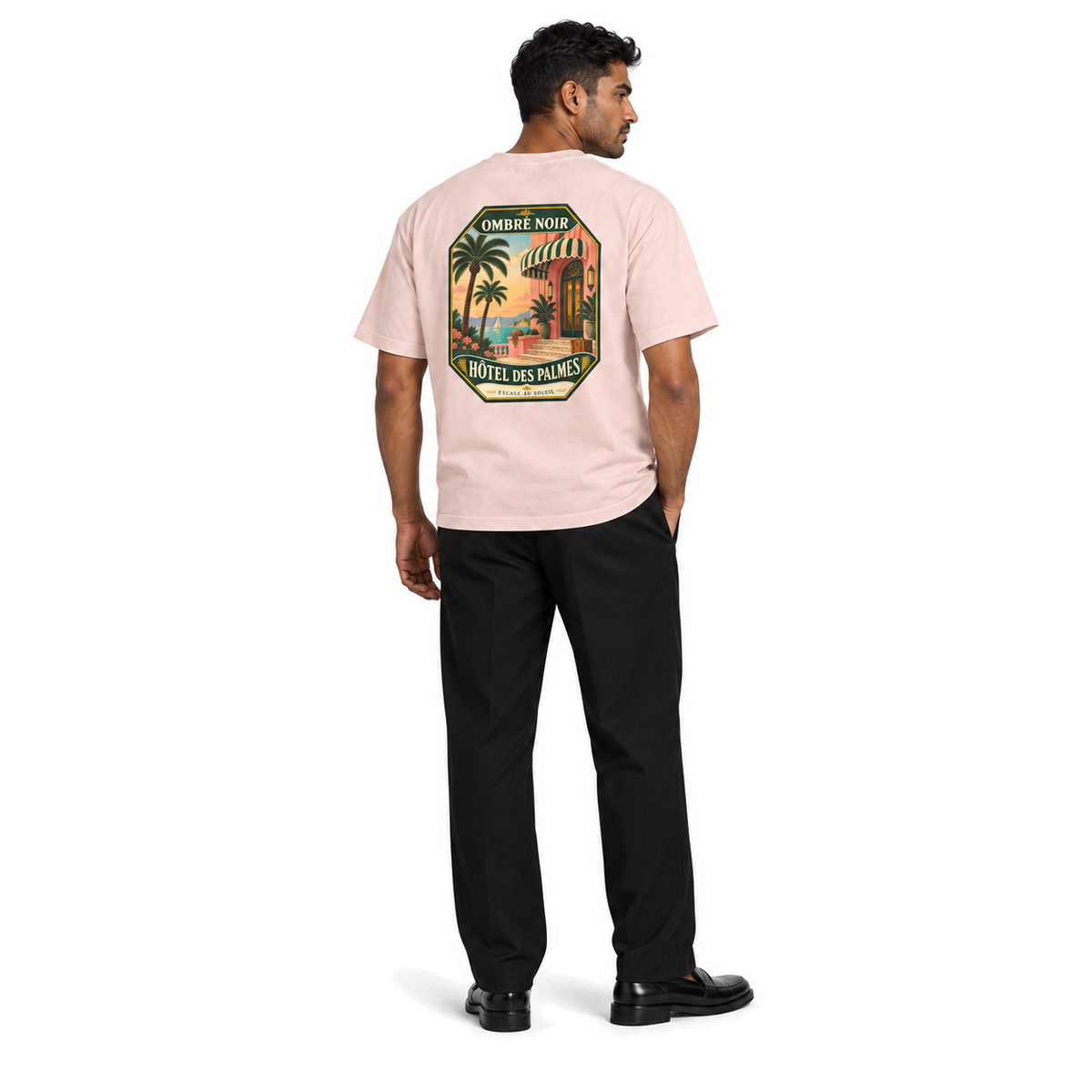 Male model wearing Hôtel des Palmes Graphic Tee in Salmon, back print visible