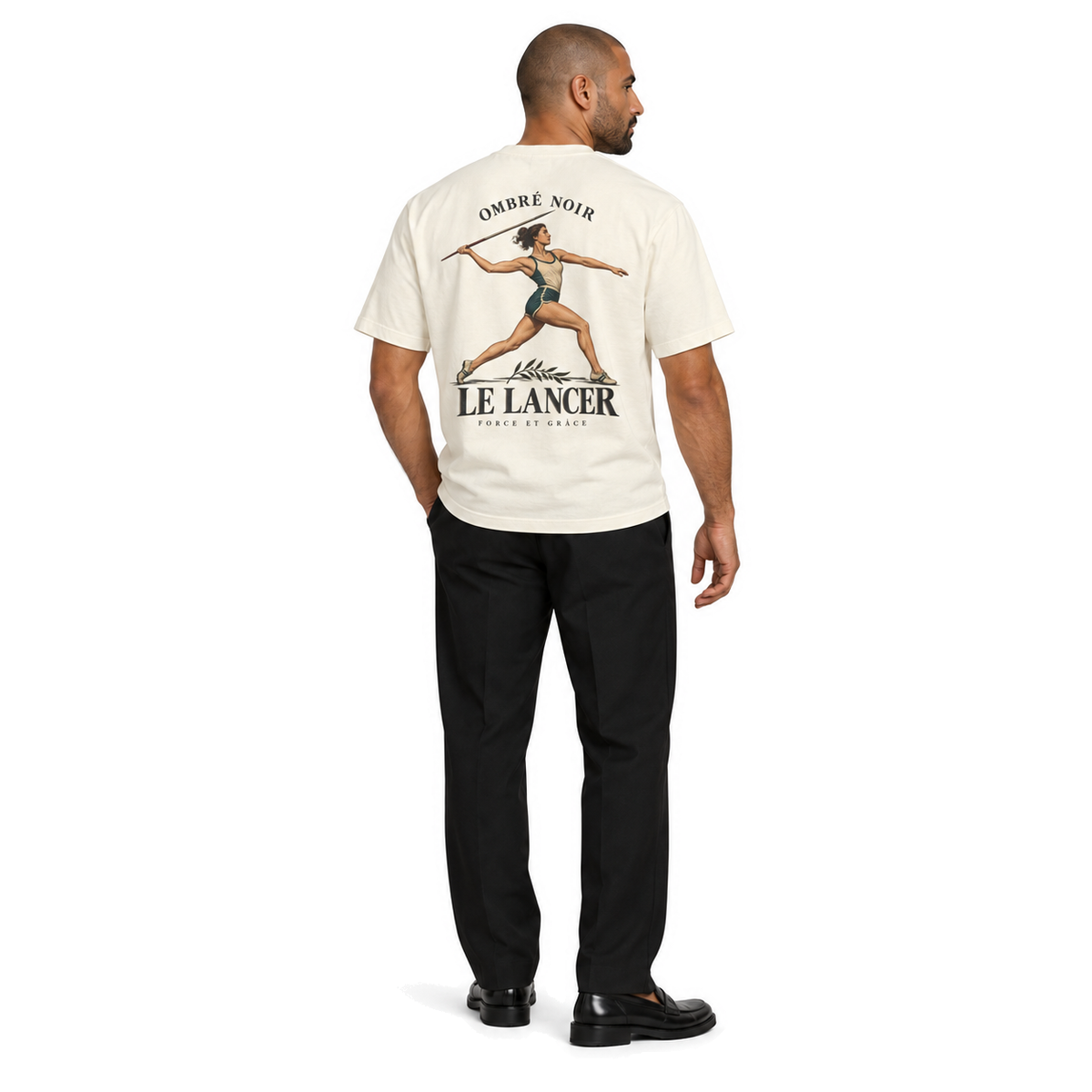Male model wearing Le Lancer Graphic Tee in Faded Cream, back print visible