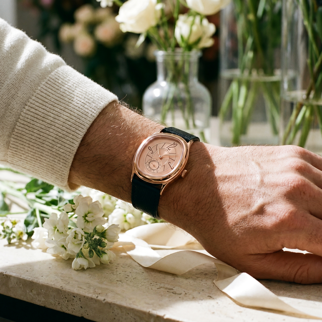 Reverie Rose Gold watch worn on a wrist among white flowers