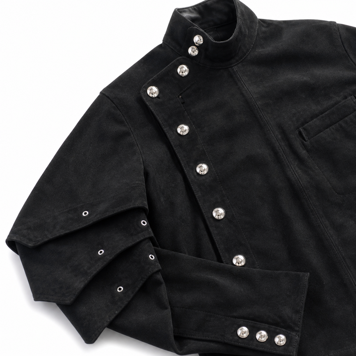 Close-up of Riven Noir jacket layered pleats and metal hardware closure