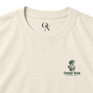 The Sculpture Garden Faded Cream tee detail: collar, inner-neck mark and green bust chest print