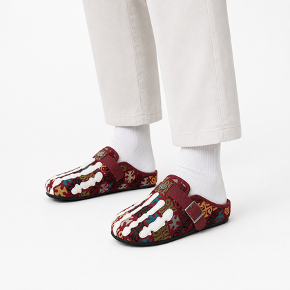 Model wearing Talisman Crimson tapestry mules in a white studio