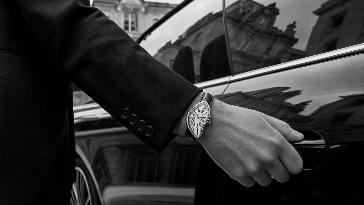 Black and white wrist shot beside a car